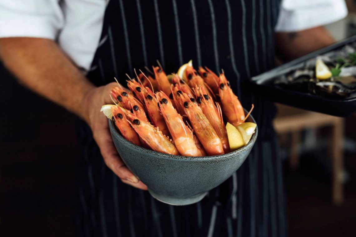 mooloolaba-surf-club-chef-with-bowl-of-prawns